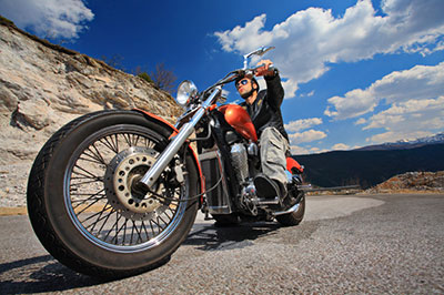 image of man riding motorcycle on highway in Tennessee